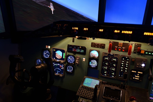 The inside of a flight simulator with controls, dials, and screens.